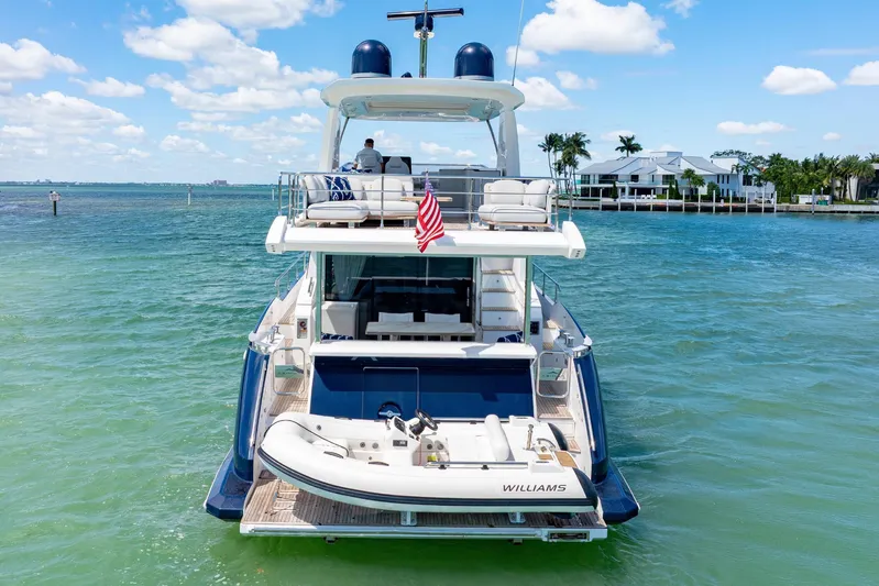  Yacht Photos Pics Azimut 60 Fly 2020 yacht on clear blue water, rear view with tender boat.