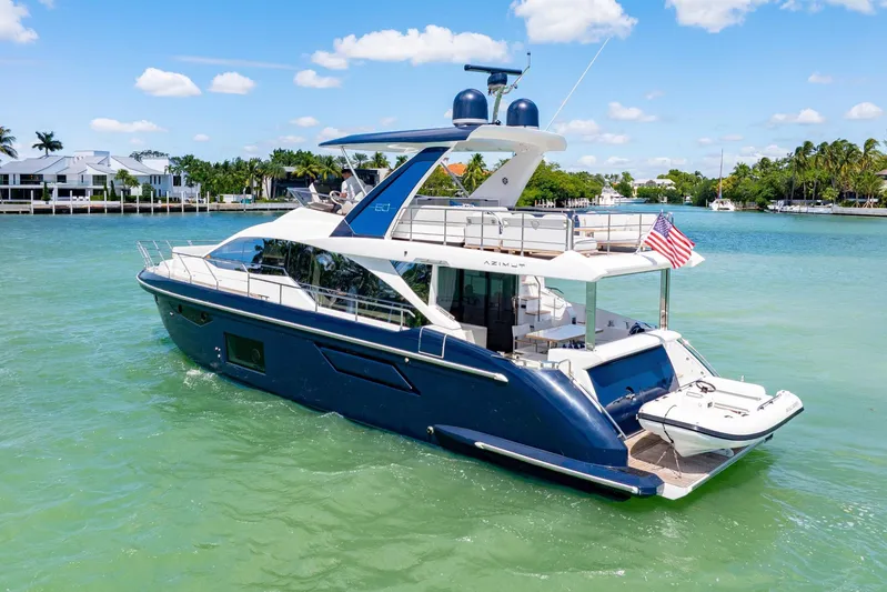  Yacht Photos Pics Azimut 60 Fly 2020 yacht cruising on turquoise water under a clear blue sky.