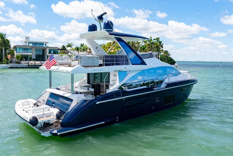  Yacht Photos Pics Azimut 60 Fly 2020 yacht cruising on clear blue waters, with modern design and American flag.