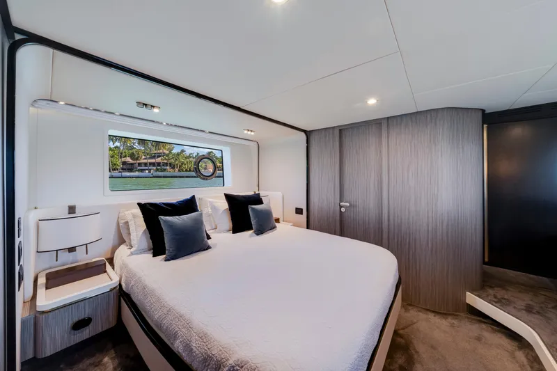  Yacht Photos Pics Luxurious bedroom interior of 2020 Azimut 60 Fly yacht with modern design and scenic window view.