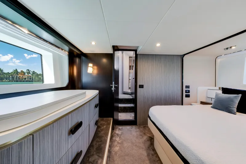  Yacht Photos Pics Luxurious bedroom interior of 2020 Azimut 60 Fly yacht with modern design and scenic window view.