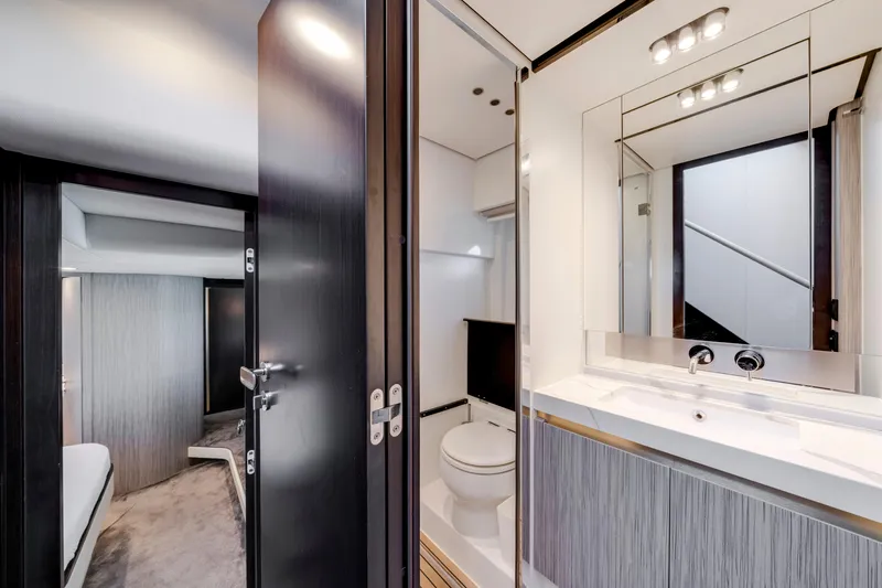  Yacht Photos Pics Luxurious bathroom interior of 2020 Azimut 60 Fly yacht, featuring modern fixtures and elegant design.