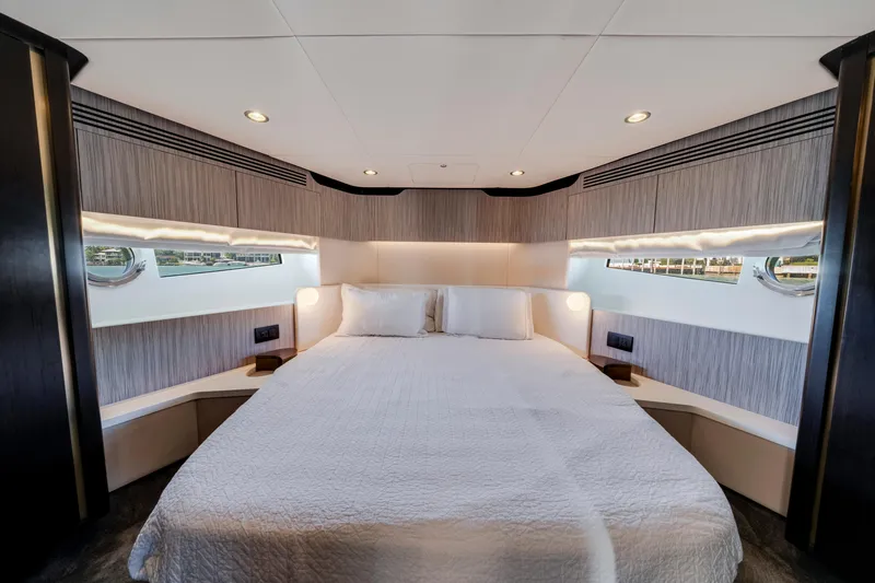  Yacht Photos Pics Luxurious bedroom interior of 2020 Azimut 60 Fly yacht with modern design and ambient lighting.
