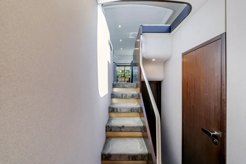  Yacht Photos Pics Interior staircase of 2020 Azimut 60 Fly yacht, featuring modern design and elegant finishes.