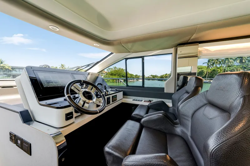  Yacht Photos Pics Luxurious interior of 2020 Azimut 60 Fly yacht with modern steering and leather seating.