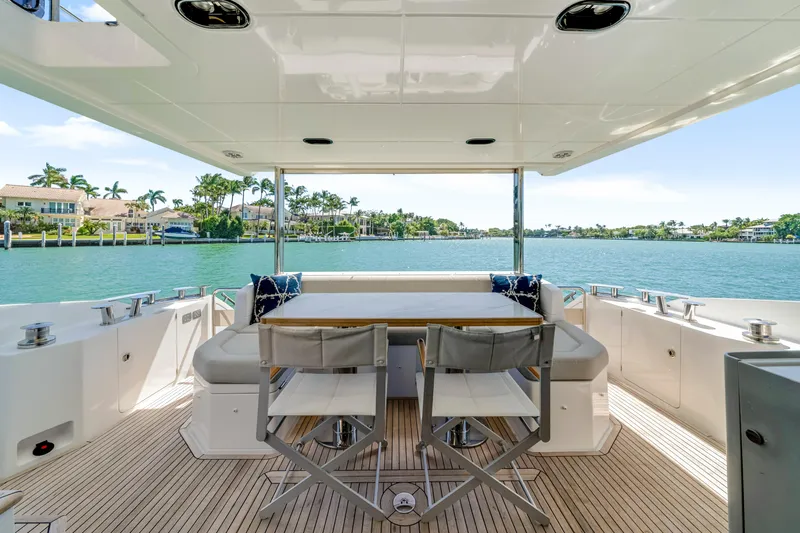  Yacht Photos Pics Luxurious Azimut 60 Fly yacht deck with seating, overlooking serene waterfront views.