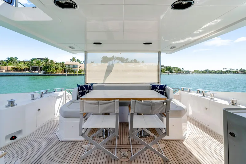  Yacht Photos Pics Luxurious 2020 Azimut 60 Fly yacht deck with seating, overlooking serene waterfront views.