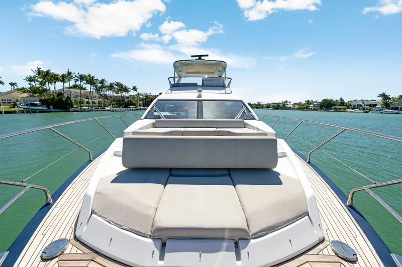  Yacht Photos Pics Luxurious 2020 Azimut 60 Fly yacht on serene water, featuring spacious sunbathing area.