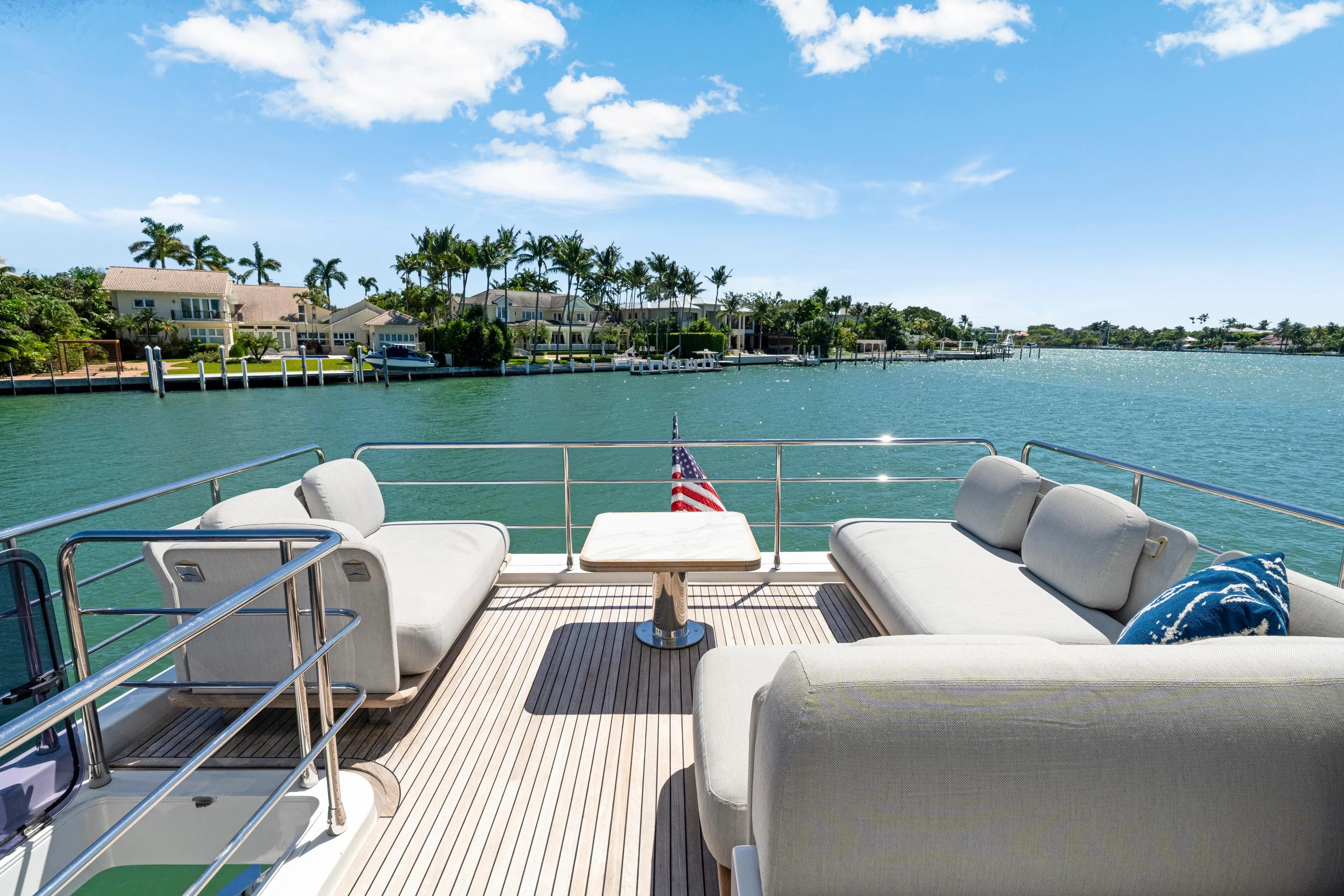  Yacht Photos Pics Luxurious Azimut 60 Fly yacht deck with comfortable seating, overlooking serene waterfront homes.