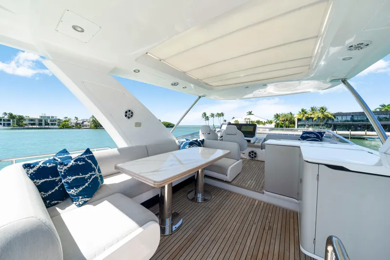 Yacht Photos Pics Luxurious 2020 Azimut 60 Fly yacht with elegant seating and scenic waterfront view.