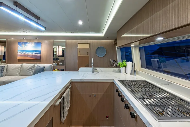 Oasis Yacht Photos Pics Luxurious 2023 Horizon PC60 yacht interior with modern kitchen and elegant design.