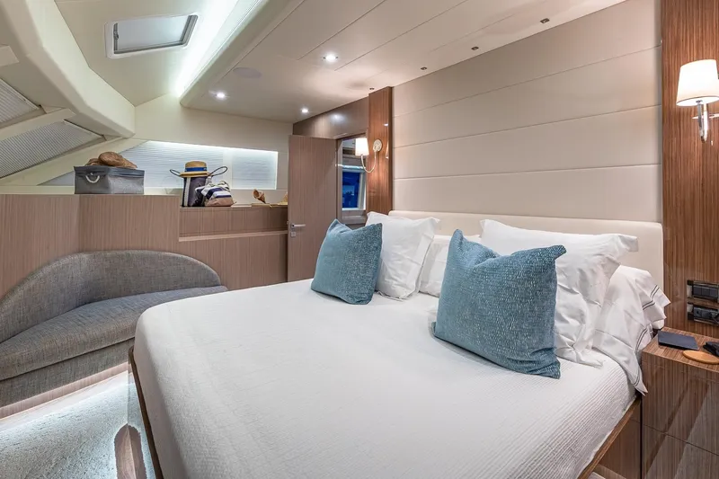 Oasis Yacht Photos Pics Luxurious 2023 Horizon PC60 yacht bedroom with elegant decor and plush bedding.