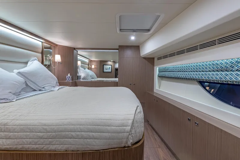 Oasis Yacht Photos Pics Luxurious cabin interior of 2023 Horizon PC60 yacht with elegant bedding and modern design.