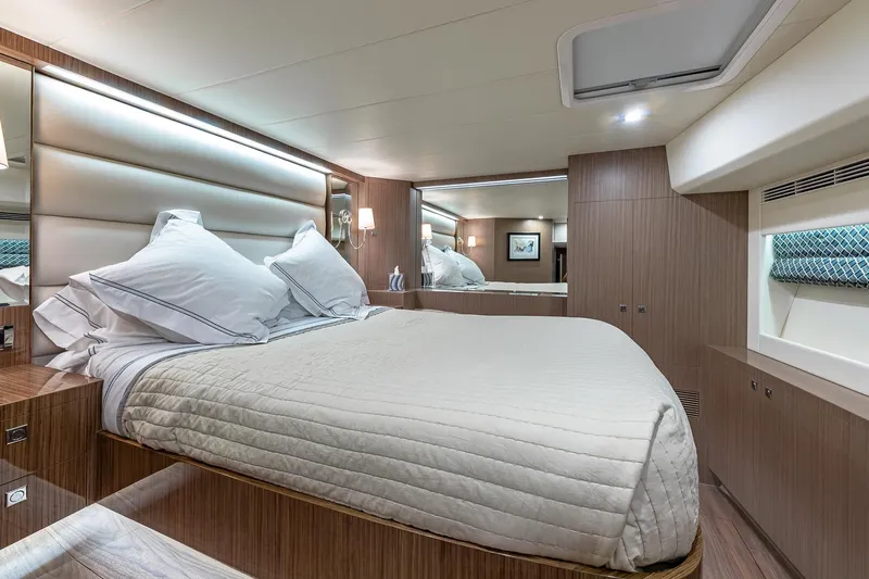 Oasis Yacht Photos Pics Luxurious bedroom interior of 2023 Horizon PC60 yacht with modern design and elegant bedding.