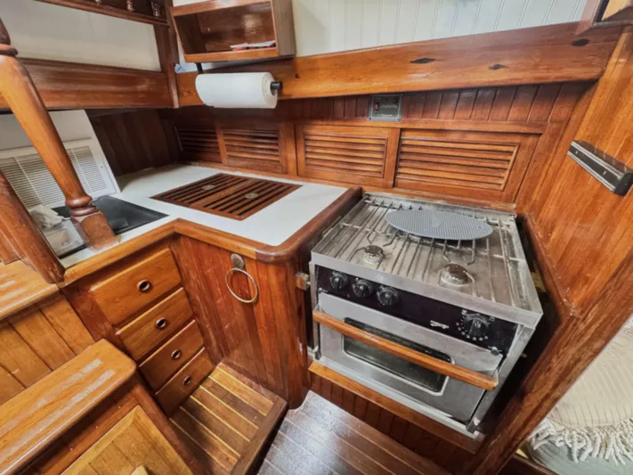 Yacht Photos Pics Wooden galley kitchen in 1980 Hans Christian 38 MKII sailboat with stove and storage.