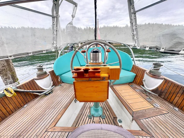  Yacht Photos Pics Cockpit of 1980 Hans Christian 38 MKII sailboat with wooden deck and turquoise seating.
