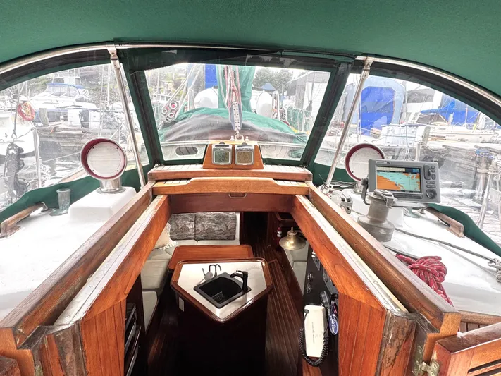  Yacht Photos Pics Cockpit of 1980 Hans Christian 38 MKII sailboat with navigation equipment and wooden interior.