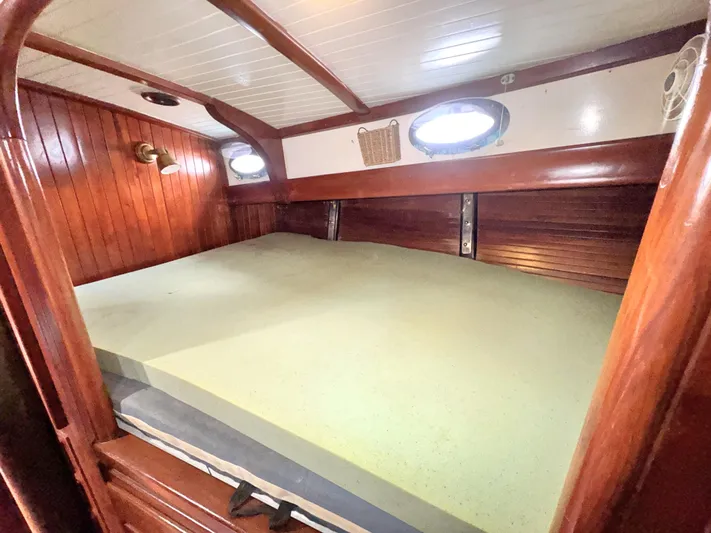  Yacht Photos Pics Cozy cabin interior of 1980 Hans Christian 38 MKII sailboat with wooden paneling and portholes.