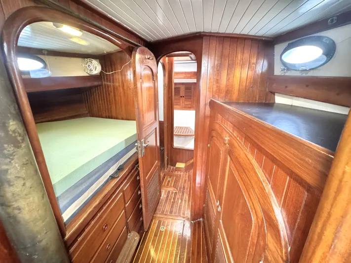  Yacht Photos Pics Interior of 1980 Hans Christian 38 MKII sailboat with wooden cabinetry and cozy sleeping area.