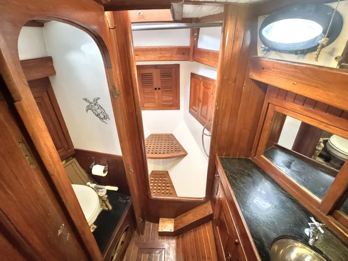  Yacht Photos Pics 1980 Hans Christian 38 MKII yacht bathroom with wooden interior, sink, and nautical decor.