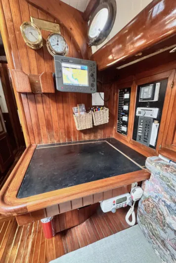  Yacht Photos Pics Navigation station on a 1980 Hans Christian 38 MKII sailboat with wood paneling and instruments.