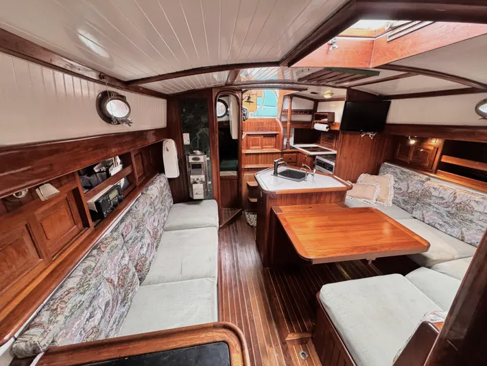  Yacht Photos Pics Interior of 1980 Hans Christian 38 MKII sailboat with wood finish and cozy seating area.