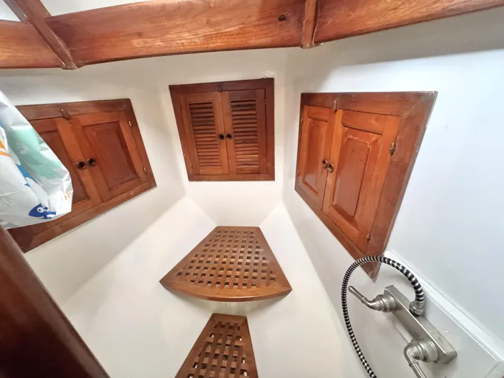  Yacht Photos Pics Wooden interior of 1980 Hans Christian 38 MKII sailboat with cabinets and shower.