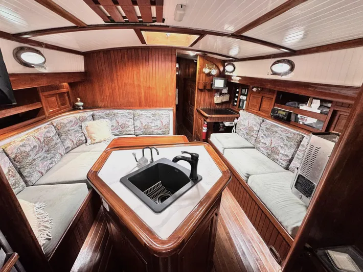  Yacht Photos Pics Interior of 1980 Hans Christian 38 MKII sailboat with cozy seating and wooden finishes.