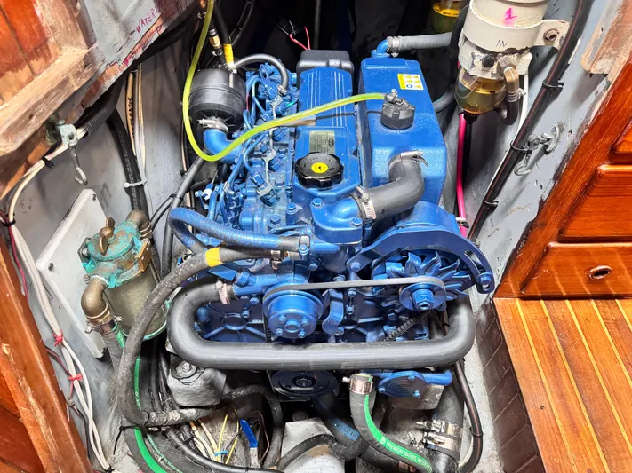  Yacht Photos Pics Engine compartment of a 1980 Hans Christian 38 MKII sailboat, featuring a blue marine engine.