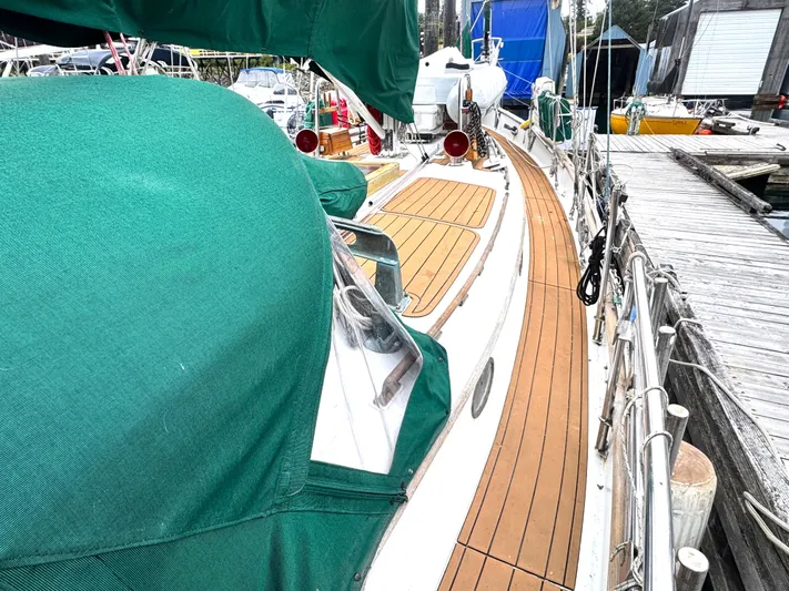  Yacht Photos Pics 1980 Hans Christian 38 MKII sailboat with green covers docked at a marina.