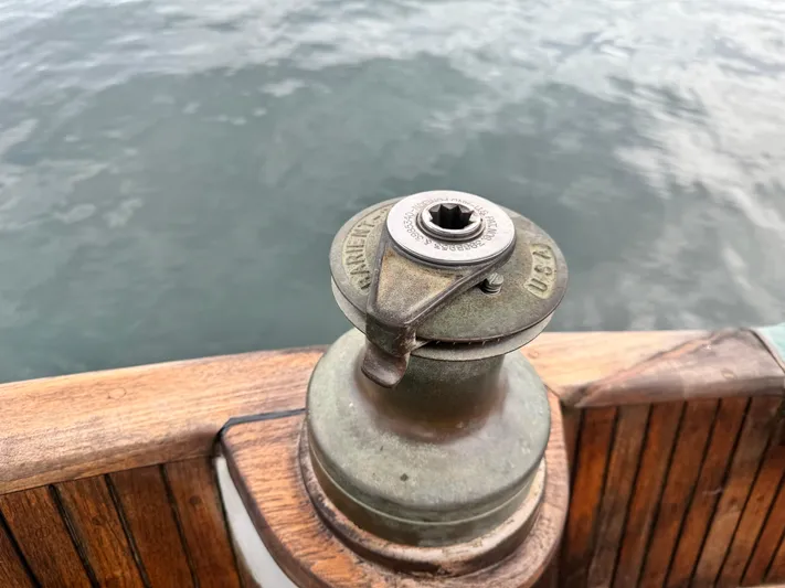  Yacht Photos Pics Vintage winch on 1980 Hans Christian 38 MKII sailboat, with wooden deck and ocean background.