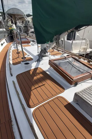  Yacht Photos Pics 1980 Hans Christian 38 MKII sailboat deck with teak accents and green sail cover.