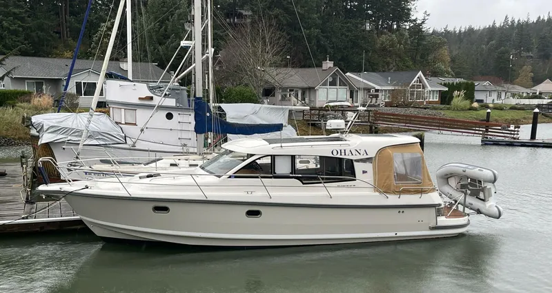 Ohana Yacht Photos Pics 2019 Nimbus 365 Coupe boat docked in a serene marina setting.