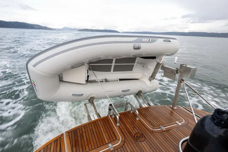 Ohana Yacht Photos Pics Nimbus 365 Coupe 2019 with inflatable boat on wooden deck, cruising on open water.
