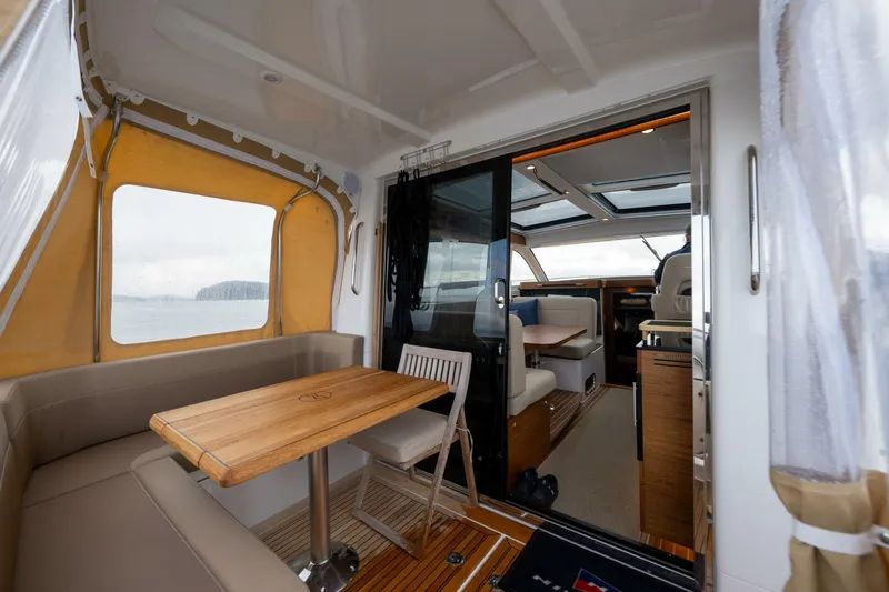 Ohana Yacht Photos Pics 2019 Nimbus 365 Coupe interior with dining area and cockpit view.