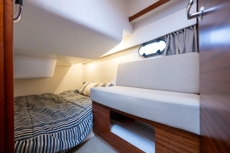 Ohana Yacht Photos Pics Interior cabin of 2019 Nimbus 365 Coupe with bed and seating area.