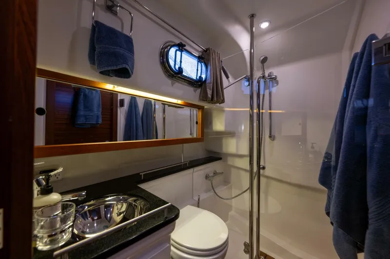 Ohana Yacht Photos Pics Luxurious bathroom in 2019 Nimbus 365 Coupe yacht with modern fixtures and elegant design.