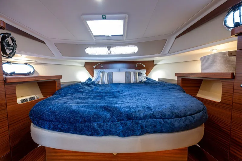 Ohana Yacht Photos Pics Luxurious cabin interior of 2019 Nimbus 365 Coupe with plush blue bedding.