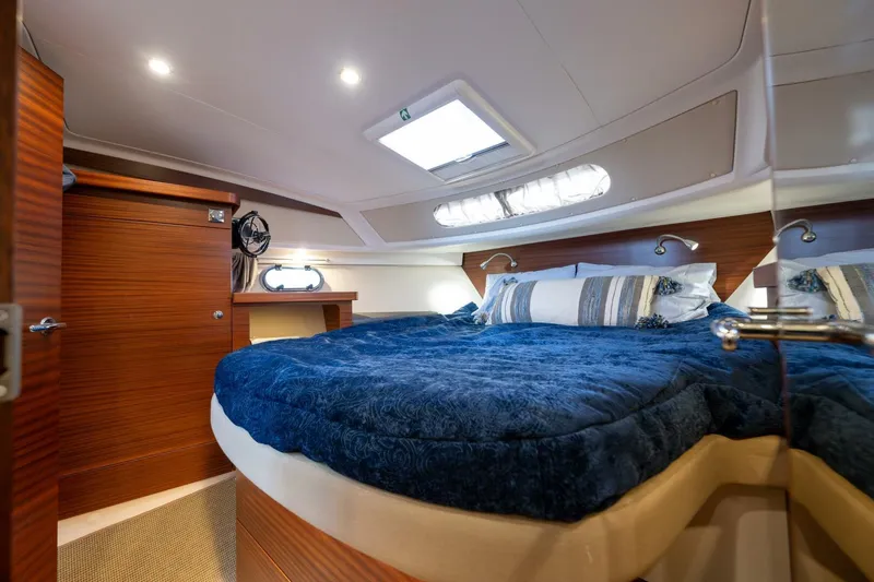 Ohana Yacht Photos Pics Luxurious cabin interior of 2019 Nimbus 365 Coupe with cozy bedding and wooden accents.