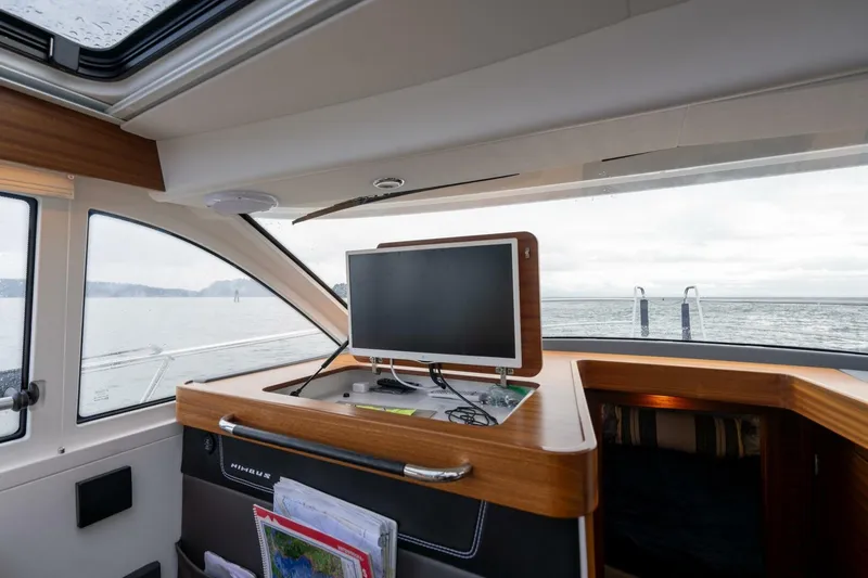 Ohana Yacht Photos Pics Interior of a 2019 Nimbus 365 Coupe boat with a navigation screen.