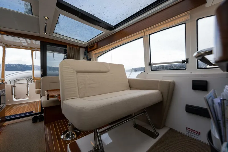 Ohana Yacht Photos Pics Interior of 2019 Nimbus 365 Coupe with beige seating and panoramic windows.
