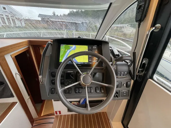 Ohana Yacht Photos Pics Steering wheel and navigation system of 2019 Nimbus 365 Coupe boat interior.