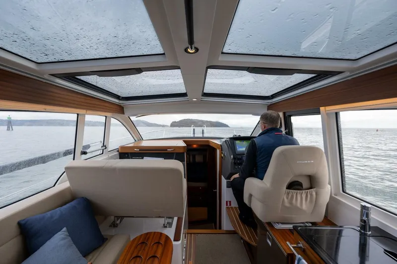 Ohana Yacht Photos Pics Interior of 2019 Nimbus 365 Coupe yacht with panoramic windows and modern helm.