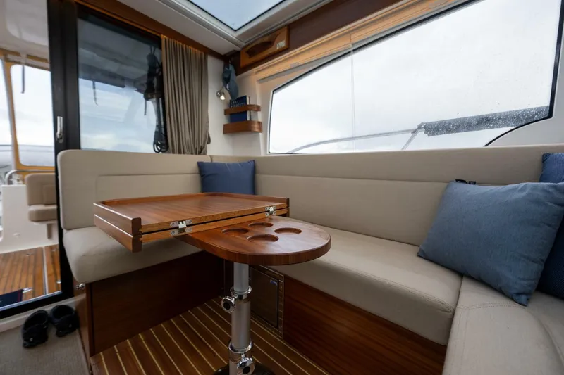 Ohana Yacht Photos Pics Interior of 2019 Nimbus 365 Coupe with cozy seating and wooden table.