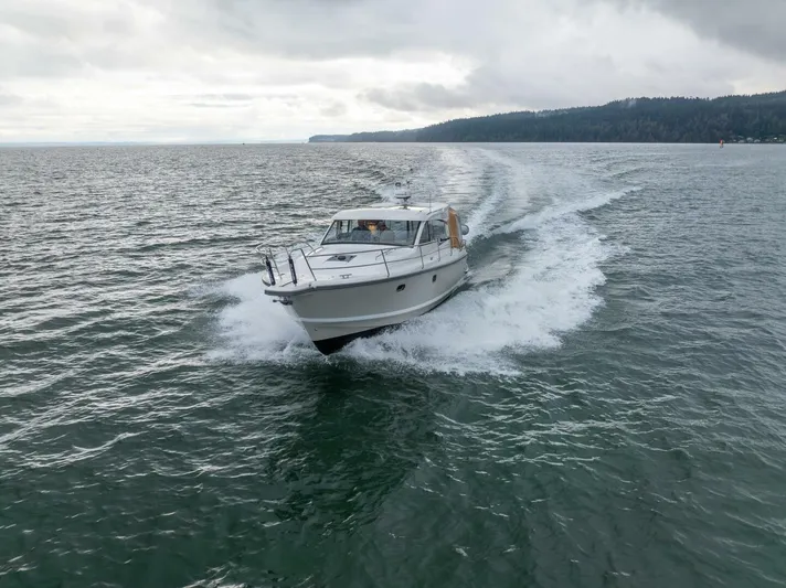 Ohana Yacht Photos Pics 2019 Nimbus 365 Coupe cruising on open water under cloudy skies.