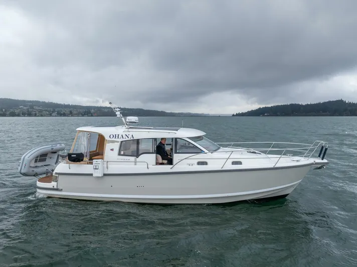 Ohana Yacht Photos Pics 2019 Nimbus 365 Coupe boat on a cloudy day, cruising in open water.