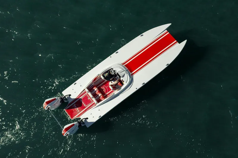  Yacht Photos Pics Aerial view of 2022 HellKats 32 speedboat with red and white design on water.
