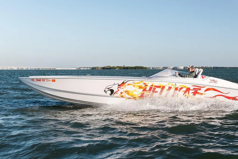  Yacht Photos Pics 2022 HellKats 32 speedboat with flame graphics cruising on open water.