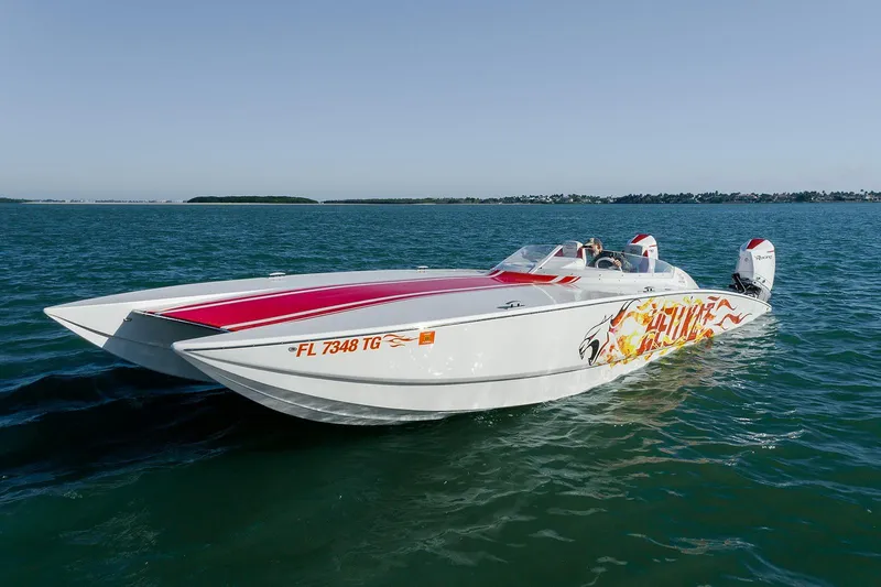  Yacht Photos Pics 2022 HellKats 32 speedboat with flame graphics cruising on open water.