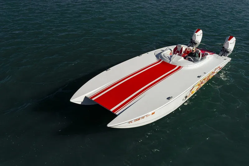  Yacht Photos Pics 2022 HellKats 32 speedboat with red stripes on open water.